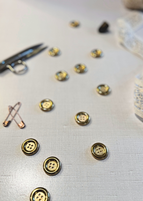 This is a gold button with a rounded wide rim